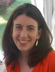 Photograph of Hilary Franklin, presenting as a white female with long, dark brown hair. She is smiling.