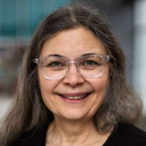 Photo of Donna Morere. Photo shows a white female with gray-brown hair and glasses.