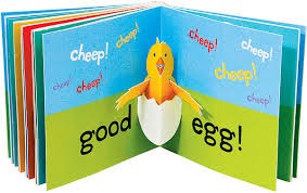 Two pages of a pop-up book. The left page says good and the right page says egg. A three-dimensional pop-up of a young chick breakout out of its egg is in the middle